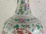 a vase with a dragon on it sitting on a table