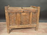 an old wooden chest sitting on top of a carpeted floor