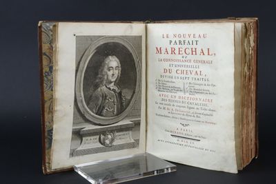 an old book with a picture of a man in a suit and tie