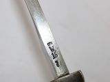 a close up of a knife on a white surface