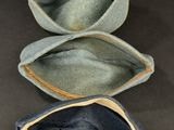 three hats are lined up on a table with a black background