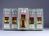 three boxes of perfumes are lined up on a table