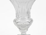 a clear glass vase with a gold label on it