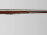 an old gun with a wooden handle on a white background