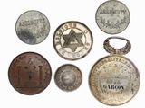 several different types of coins are displayed on a white surface
