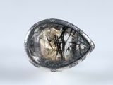 a close up of a silver ring with a large stone in it