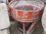 a cement mixer in the middle of a pile of cement