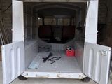 a white van with open doors in a garage