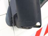 a side view mirror on the side of a white car