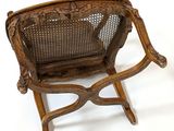 a wooden chair with a wicker seat on a white background