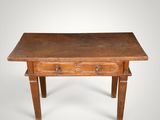 an old wooden table with two drawers and a drawer underneath it