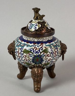 a small decorative vase with a bird on top of it