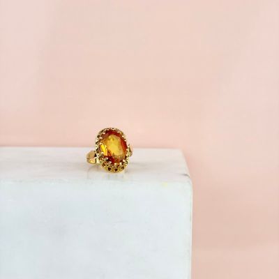 a close up of a gold ring with a citrine stone in the center