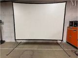 a large white screen in a room with orange cabinets
