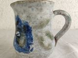 a blue and white vase sitting on a table