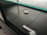 a remote control sitting on top of a glass shelf