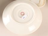 a white plate with a red and white label on it