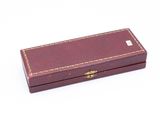 a small wooden box with a handle on a white surface