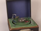 an old record player in a case with a green cover