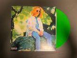 an image of a green vinyl album with a picture of a man sitting on a bench