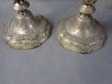 two candles that are sitting on top of a table