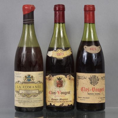 three bottles of wine are lined up on a table