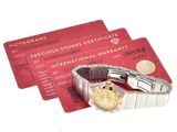 three credit cards and a watch sitting next to each other
