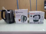 two electric kettles on the counter next to each other