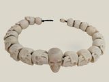 bracelet made of bone beads with a skull head on a string
