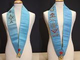 two mannequins with blue sashes on them