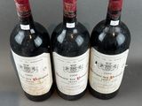 three bottles of wine sitting on top of a table next to each other