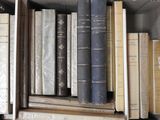 many old books on a shelf in a book case