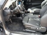 the interior of a car with the door open and the steering wheel down
