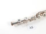 an old silver flute sitting on top of a table next to a price tag