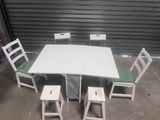 a white table with four chairs around it