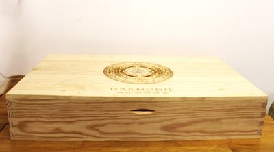 a wooden box with a logo on it sitting on a table