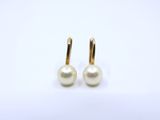 a pair of pearl earrings on a white background