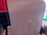 a toilet with a roll of toilet paper on the top of it