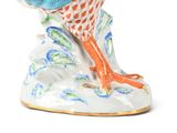 a figurine of a bird sitting on a branch