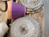 a table with a bunch of glass dishes and cups on it