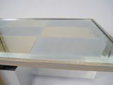 a glass table with a metal base and a glass top