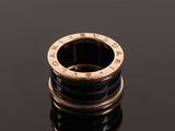 a close up of a gold and black ring on a black surface