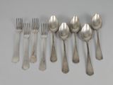 five spoons and six forks on the table