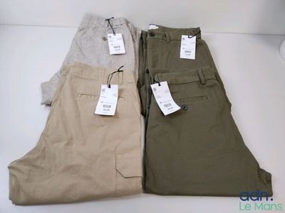 three pairs of men ' s chino pants with tags on them