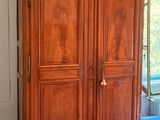 a large wooden armoire in the corner of a room