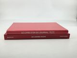 a red book sitting on top of a white table