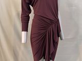 the mannequin is wearing a maroon dress with a long sleeve