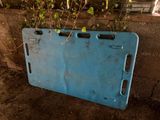 a blue metal plate that has some plants growing out of it