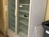 a refrigerator that is in the middle of a kitchen