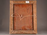 an old picture frame with a bird drawn on the side of it